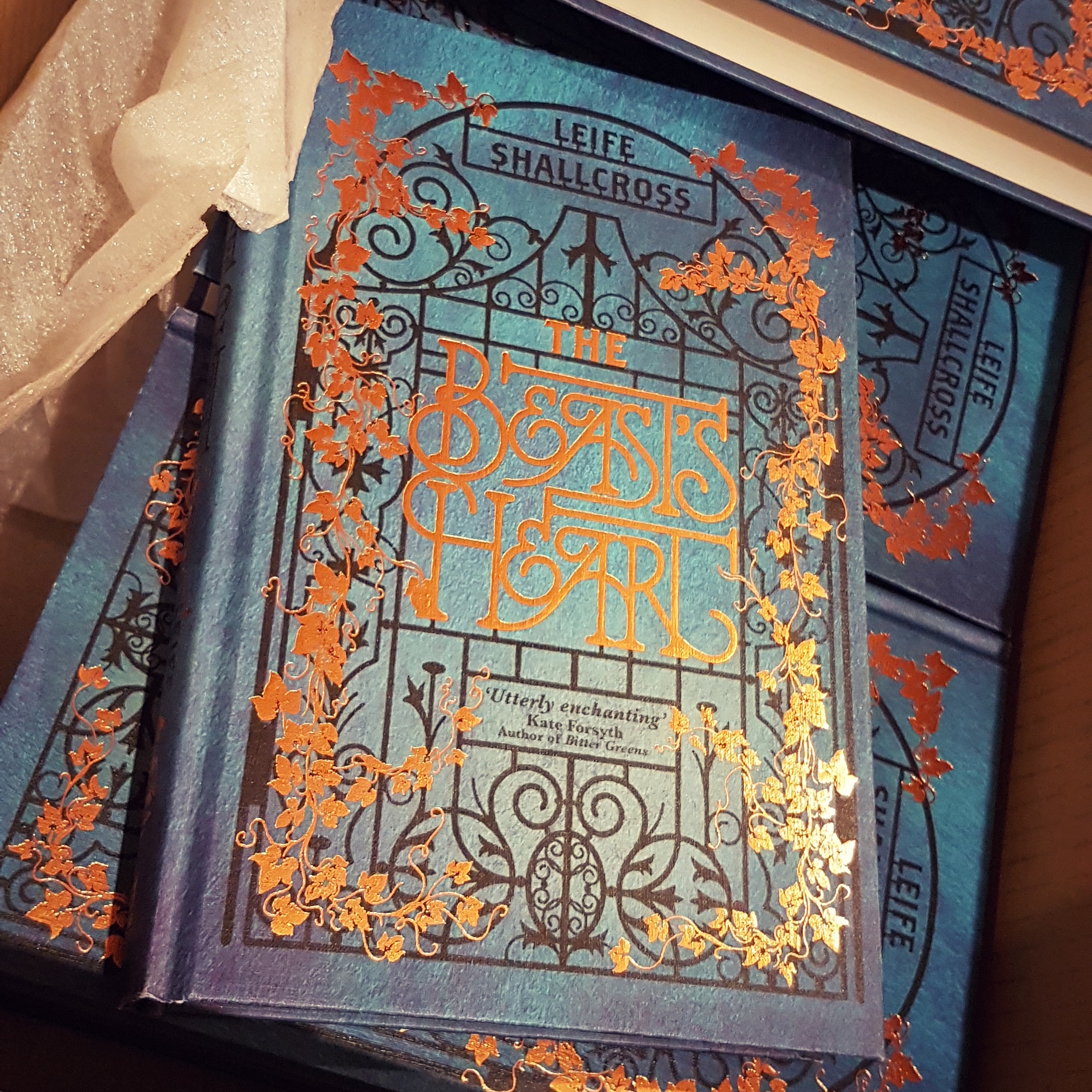 A box full of hard cover books, titled The Beast's Heart.